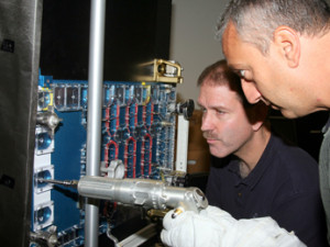 Astronauts Mike Massimino and John Grunsfeld practice procedures for repairing complex spatial NASA instruments