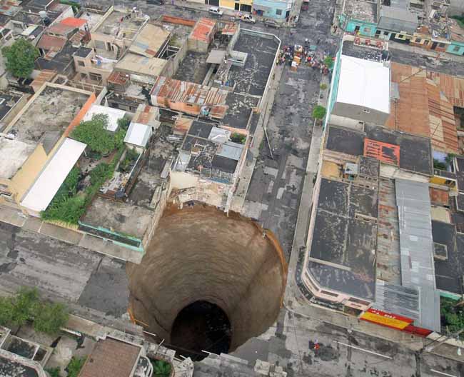 Depressed ground in Guatemala City: This sinkhole was estimated to be 60 feet wide and 300 feet deep